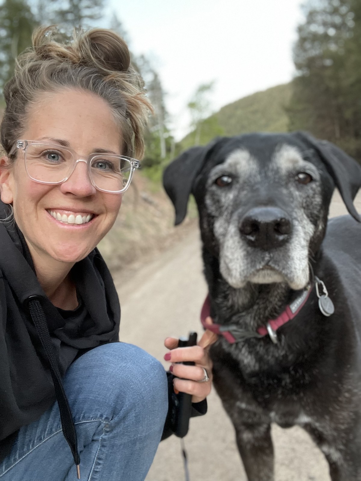 Heidi Shabo, Client Experience Coordinator at Cement Creek Veterinary Hospital, outside with her senior dog